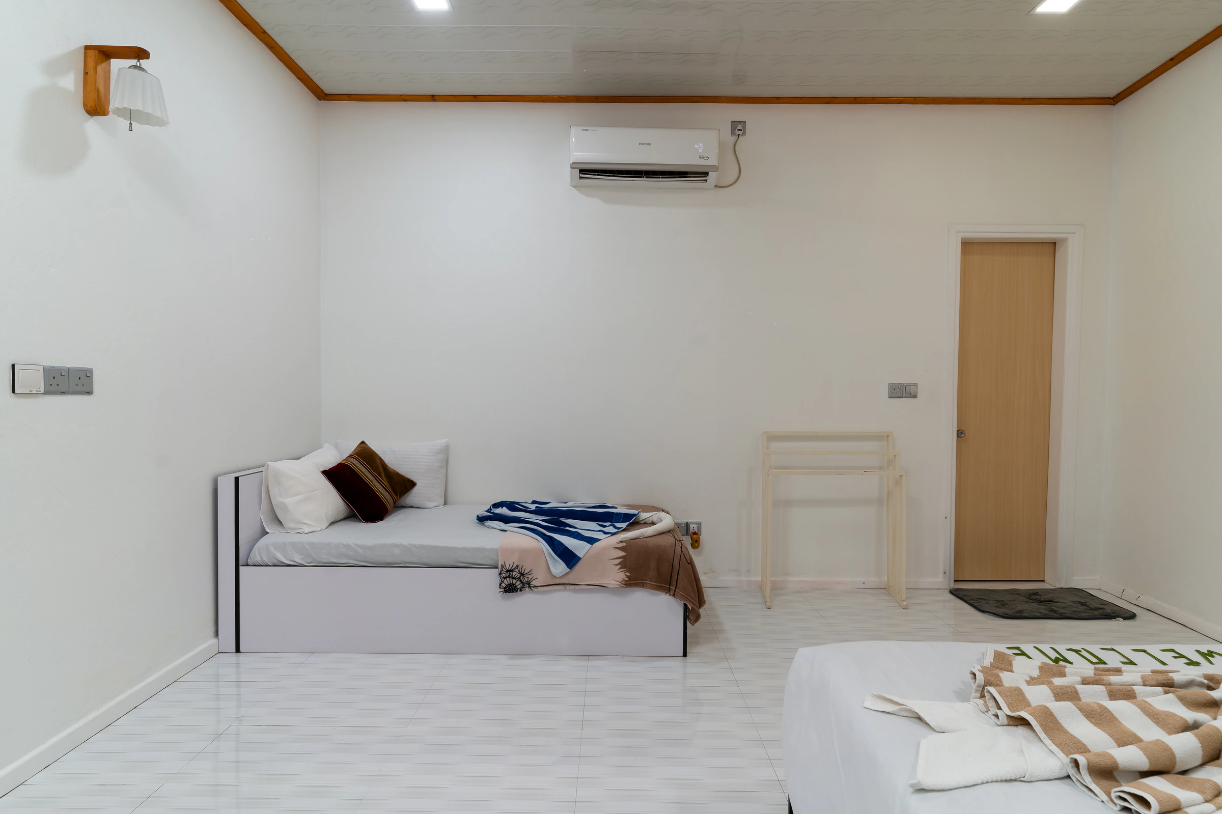 A Maafolhey bedroom with two beds, part of the same single booking