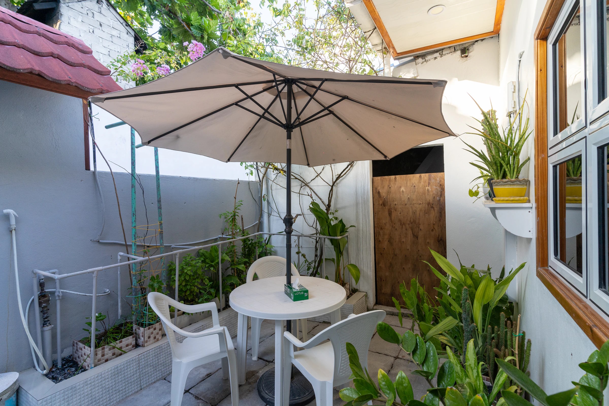 The courtyard off the living room, with table, chairs and umbrella