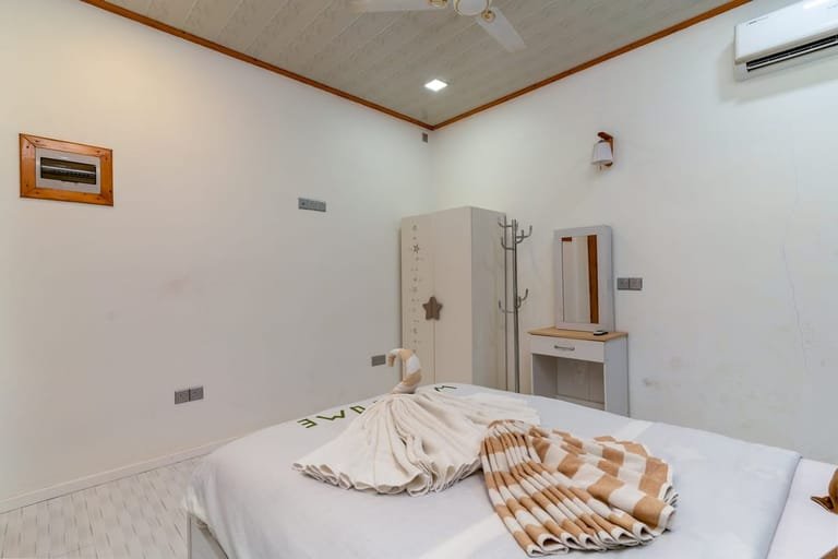 Double bedroom with welcome towel art and wardrobe