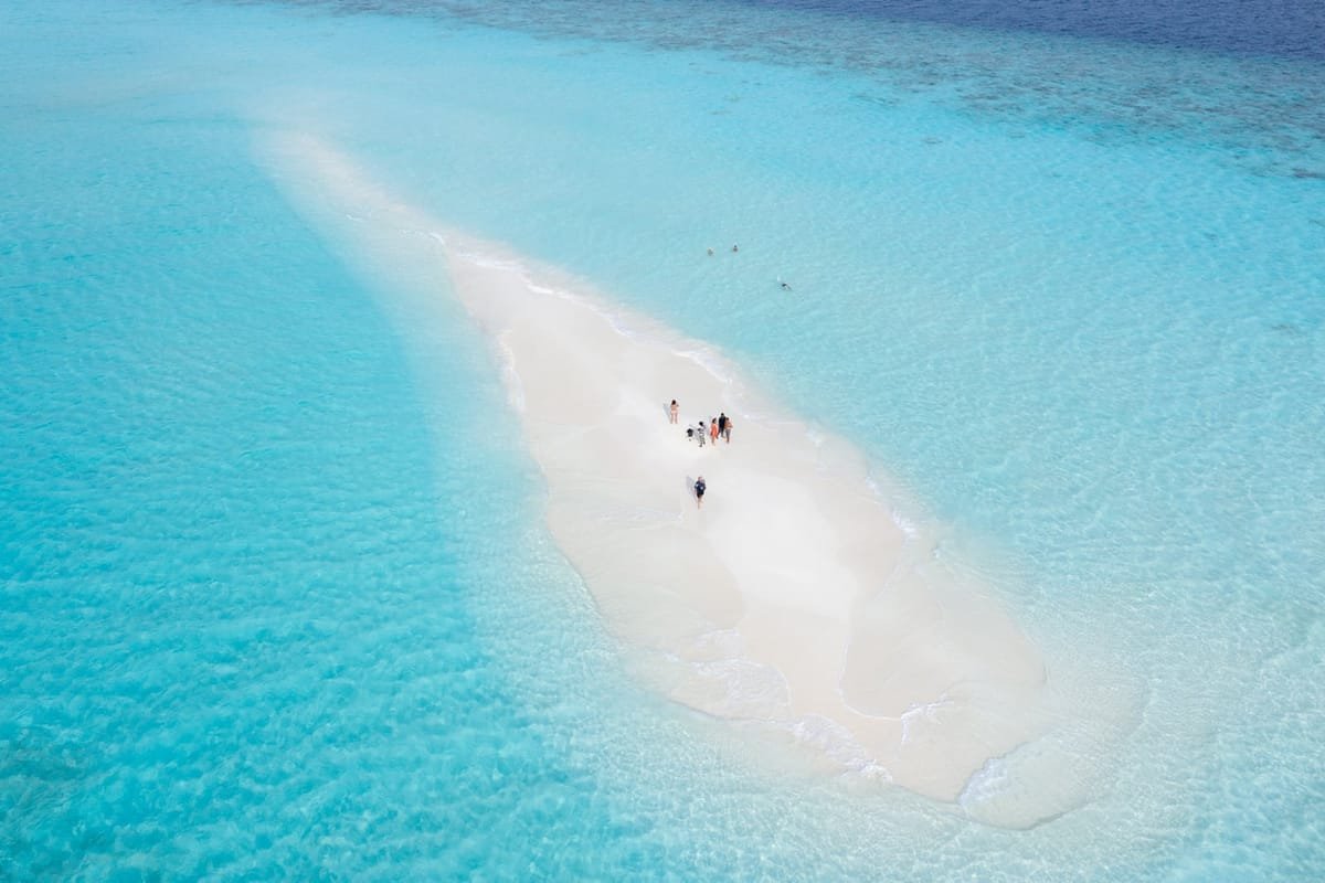 Aerial view of Ukulhas island, Maldives, with turquoise lagoon and white sandbank