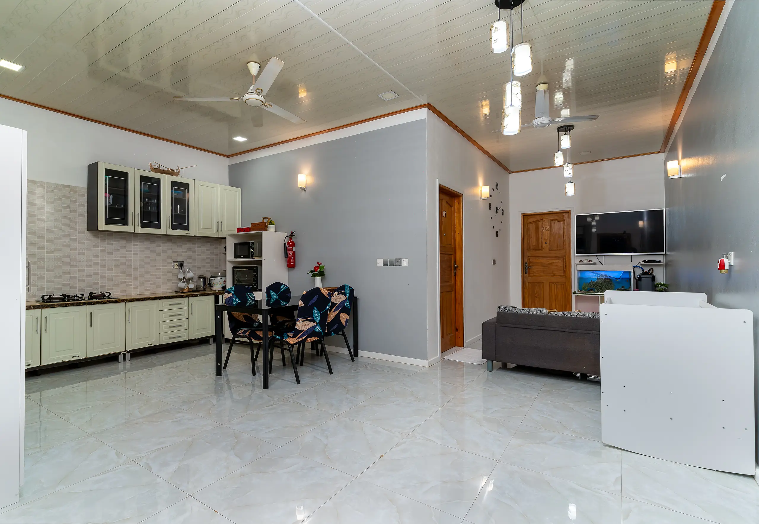 The kitchen, dining table and living area at Maafolhey, seen as one connected space